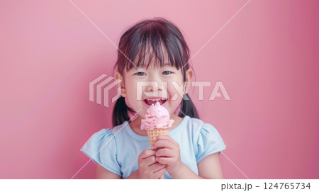 Little girl eating vanilla ice cream dessert in summer copy space isolated pink background 124765734