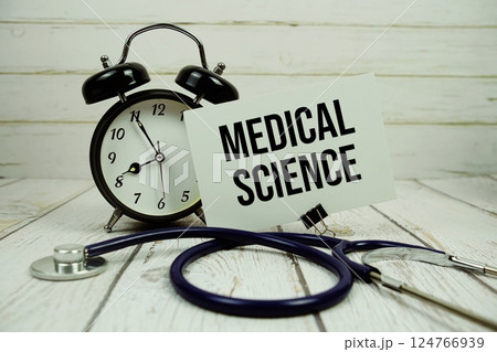 Medical Science text on paper card with alarm clock and stethoscope on wooden background 124766939