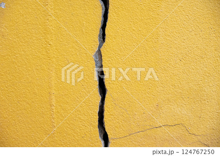 Full frame shot of cracked wall. Wider cracks often represent serious structural damage and can cause serious issues. 124767250
