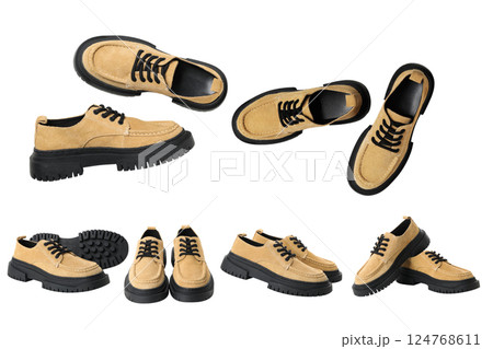 These suede shoes feature a black sole, perfect for various settings, isolated on white 124768611