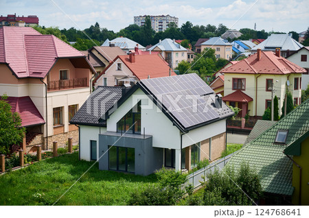 House with solar panels on rooftop for generating electricity through photovoltaic effect. Home with solar power system on roof. Concept of alternative energy, autonomy, power sustainable resources. 124768641