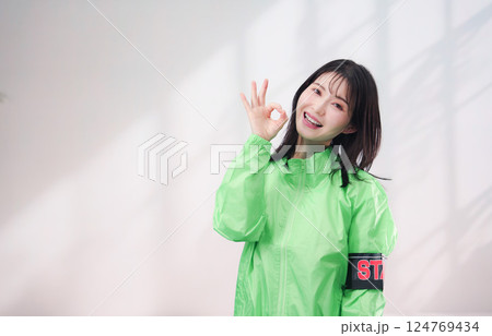 スタッフジャンパーをきた笑顔のイベントスタッフ（シンプル背景） 124769434