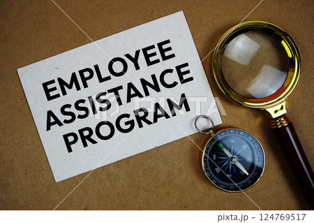 Employee Assistance Program text on paper torn with compass and magnifying glass on paper craft background Employee Assistance Program text on paper torn with compass and magnifying glass on paper craft background 124769517