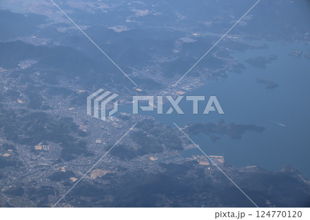 March 22 2025 Aerial View of Coastal Town Surrounded by Hills, Japan March 22 2025 Aerial View of Coastal Town Surrounded by Hills, Japan 124770120