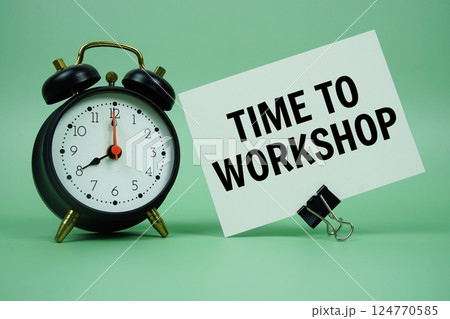 Time To Workshop text message on paper card with alarm clock on green background 124770585