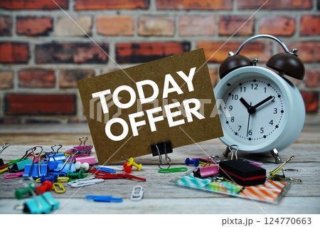 Today Offer text on paper card with alarm clock and stationary on wooden background Today Offer text on paper card with alarm clock and stationary on wooden background 124770663