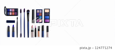 A cosmetic palette featuring white shadows, a makeup product with various shades, accompanied by a brush and a tube for application. The product is isolated on a clean background. Copy space banner 124771274