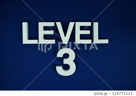 Level 3 Level Three alphabet letters on navy blue background Level 3 Level Three alphabet letters on navy blue background 124772121