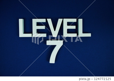 Level 7 Level Seven alphabet letters on navy blue background 124772125