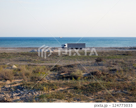 The truck is standing on the shore. The truck is standing on the shore. 124773033