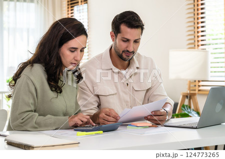 Couple budgeting and calculating tax with laptop at home, managing finance and planning for longterm investment 124773265