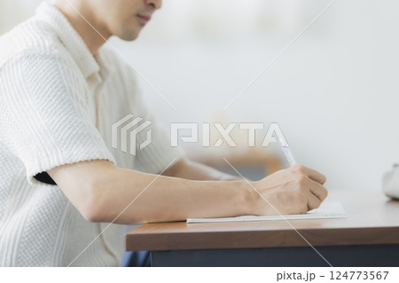 リビングで勉強をする30代男性 リビングで勉強をする30代男性 124773567