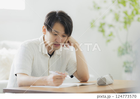 リビングで勉強をする30代男性 リビングで勉強をする30代男性 124773570