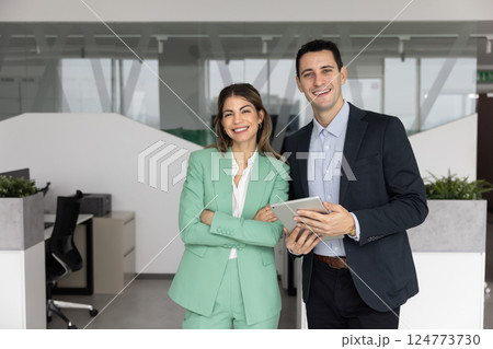 Couple of Latin business partners posing for portrait in office 124773730