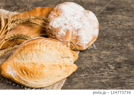 Homemade natural breads. Different kinds of fresh bread as background, perspective view with copy space 124773739