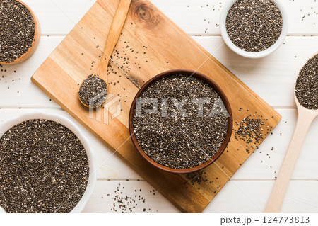 Chia seeds in bowl and spoon on colored background. Healthy Salvia hispanica in small bowl. Healthy superfood 124773813