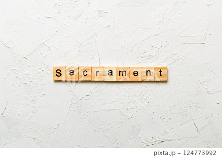 sacrament word written on wood block. sacrament text on table, concept 124773992