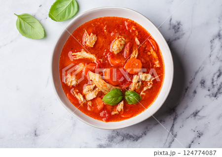 Tomato chicken soup with vegetables and basil. Tomato chicken soup with vegetables and basil. 124774087