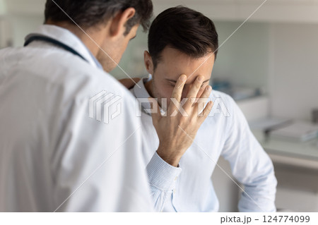 Doctor put hand on sad patients shoulder, close up 124774099