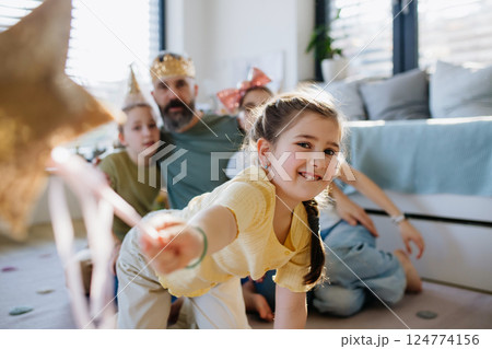 Portrait of father with three daughters at home. 124774156