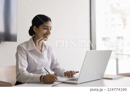 Attractive Indian woman learning or working using modern laptop 124774190