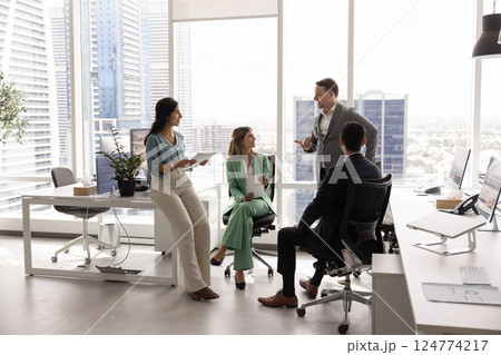 Small business team discussing teamwork in city office space 124774217