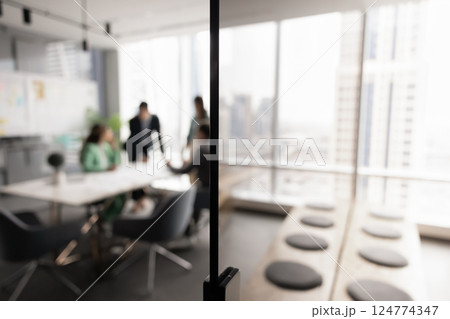 Blurred shot of small business team meeting at office table Blurred shot of small business team meeting at office table 124774347