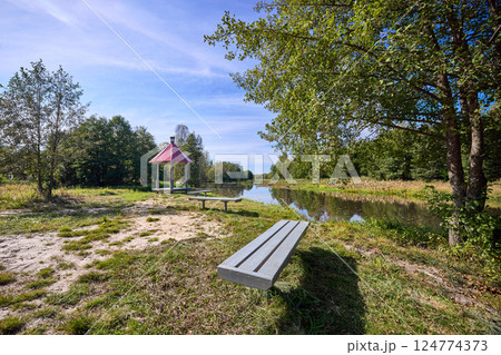 Tranquil Waterfront Gazebo on Sunny Day 124774373