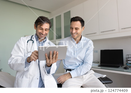 Doctor using tablet, share good news regarding patient health Doctor using tablet, share good news regarding patient health 124774409