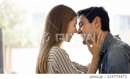 Latina couple enjoy moment of closeness with eyes closed Latina couple enjoy moment of closeness with eyes closed 124774473