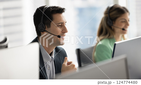 Positive Hispanic telephone support employee man speaking to customer 124774480