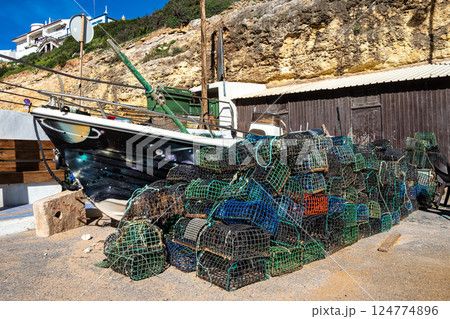 Basket fish traps in Benagil in Portugal to catch crab and lobster in the atlantic ocean 124774896