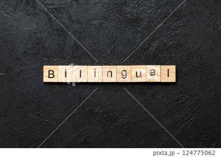bilingual word written on wood block. bilingual text on table, concept 124775062