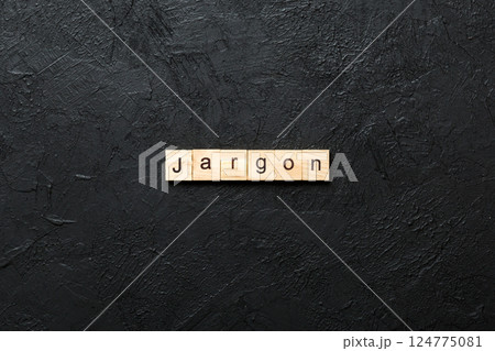 Jargon word written on wood block. Jargon text on cement table for your desing, Top view concept 124775081