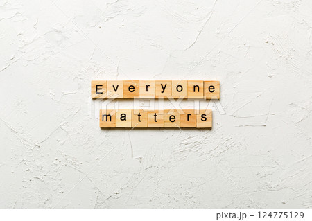 Everyone matters word written on wood block. Ever yone matterstext on cement table for your desing, Top view concept 124775129