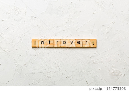 Introvert word written on wood block. Introvert text on table, concept Introvert word written on wood block. Introvert text on table, concept 124775308