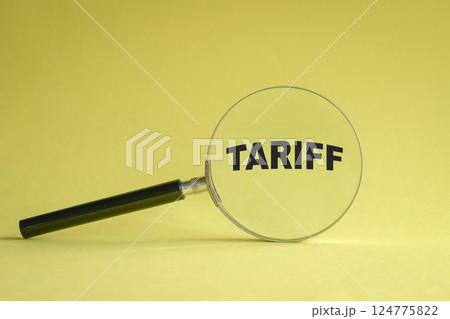 Magnifying glass on yellow background and word Tariff. 124775822