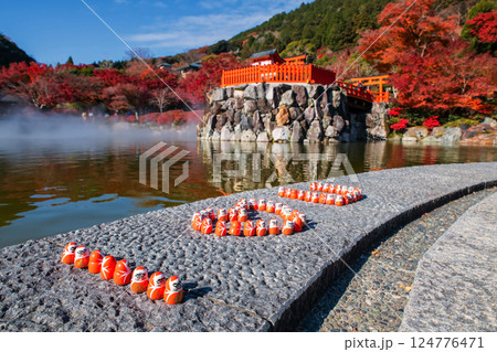 Daruma dolls with I love you word by pond in fall, Katsuoji temple, Minoh Daruma dolls with I love you word by pond in fall, Katsuoji temple, Minoh 124776471