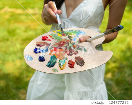 palette of paints and brushes in your hands palette of paints and brushes in your hands 124777252