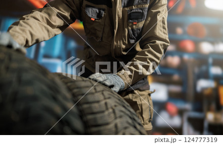 mechanic changing a wheel mechanic changing a wheel 124777319