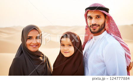 Arab family dressed in traditional Islamic clothing, The father wears a keffiyeh and thobe, while the mother and daughter wear hijabs, Arab family, symbolizing family values and cultural heritage 124777884