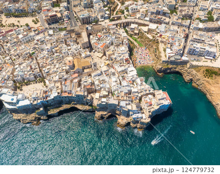 Polignano a Mare, Italy. Beach between the rocks. Aerial view of the city.  124779732