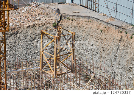 Construction crane lifts an additional section on a hook to increase the height 124780337