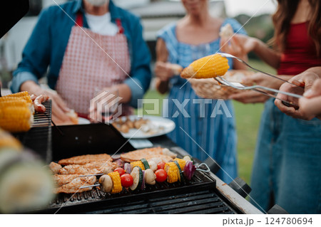 Close up of family preparing food for a spring weekend barbecue. 124780694