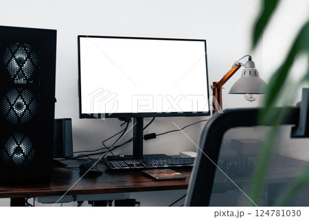 Modern home office with PC workstation for graphic designers, photographers, or video editors. Includes a computer, mouse, and white screen on a sleek brown oak desk 124781030