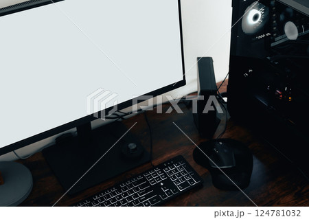 Modern home office with PC workstation for graphic designers, photographers, or video editors. Includes a computer, mouse, and white screen on a sleek brown oak desk Modern home office with PC workstation for graphic designers, photographers, or video editors. Includes a computer, mouse, and white screen on a sleek brown oak desk 124781032