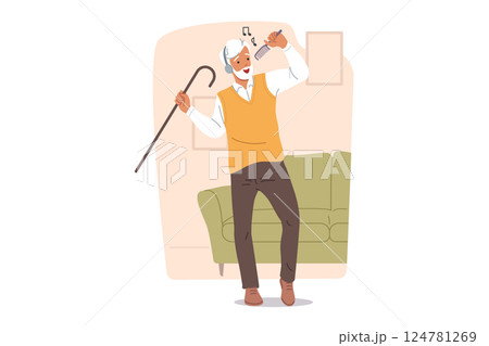 Active elderly man dances and sings while listening to music on headphones, in apartment near sofa 124781269