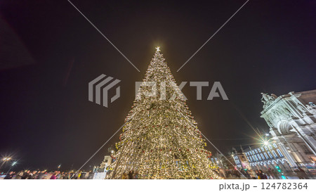 Commerce Square in Lisbon illuminated at Christmas hyperlapse, with a towering tree and crowds celebrating at night. Portugal Commerce Square in Lisbon illuminated at Christmas hyperlapse, with a towering tree and crowds celebrating at night. Portugal 124782364