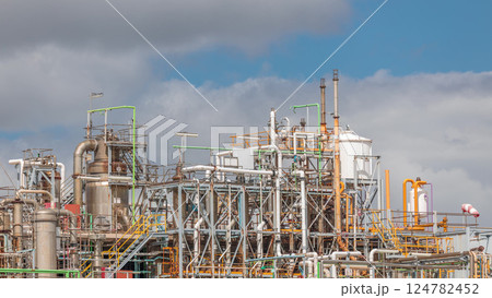 Distillation Columns and their process equipment of hydrogen plant timelapse with clouds on a background. 124782452