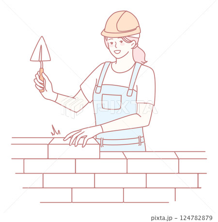 A skilled female mason worker is expertly building a sturdy wall using a trowel tool 124782879